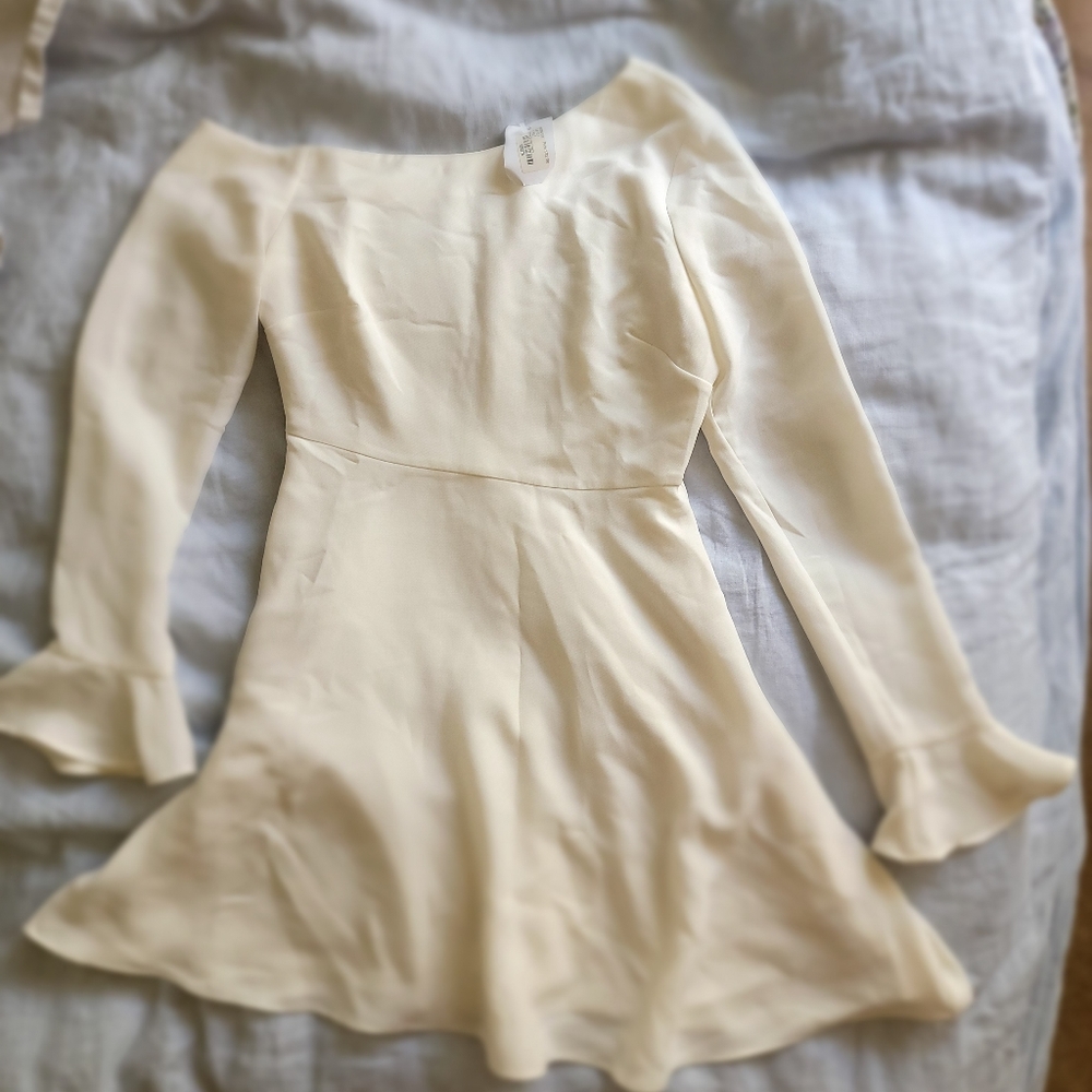 Likely white asymmetrical neckline dress